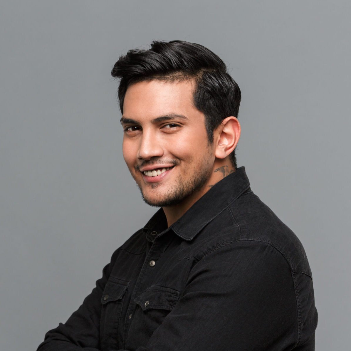 smiling young handsome man standing isolated